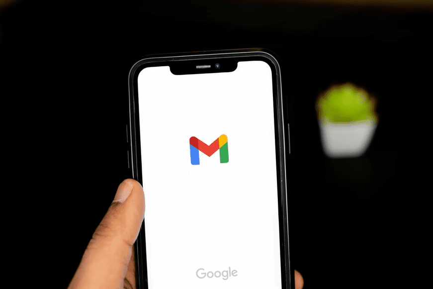 A phone screen showing Gmail logo, one of Google products.