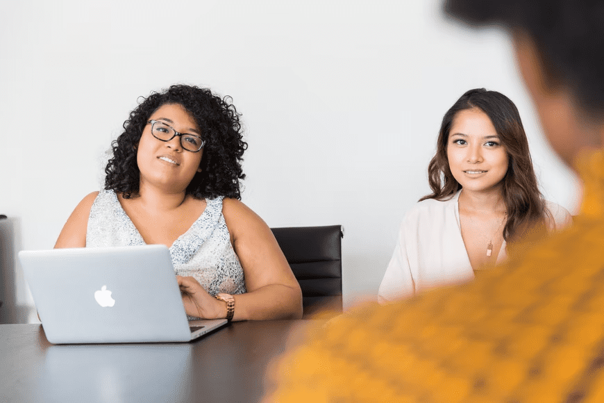 Two hiring managers interviewing a candidate.