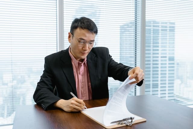 A man calculates the cost to become a business owner